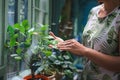 Woman wipes dust from plant