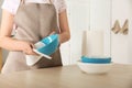 Woman wiping bowl with paper towel in kitchen Royalty Free Stock Photo