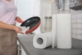 Woman wiping frying pan in kitchen Royalty Free Stock Photo