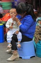 Woman is wiping snuffles of her son in Lijiang Royalty Free Stock Photo