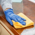 Woman wiping table countertop in kitchen by wet cloth rag. Female charwoman hand cleaning disinfect office home restaurant Royalty Free Stock Photo