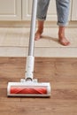 Woman with a wireless portable vacuum cleaner in the kitchen. Cleans Royalty Free Stock Photo