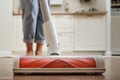 Woman with a wireless portable vacuum cleaner in the kitchen. Cleans Royalty Free Stock Photo