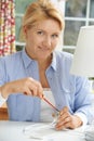 Woman Wiring Electrical Plug On Lamp At Home