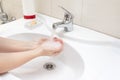 A woman wishing hands with liquid soap and water in bathroom sink. Desease prevention and hygiene concept. Useful, good habit