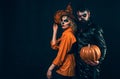 Woman witch with Pumpkin and Handsome bearded man. Enjoying nice Halloween together.