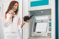 Woman withdrawing money from ATM machine