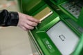 Woman withdrawing money from atm with a mobile phone a NFC terminal. Royalty Free Stock Photo