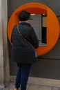 woman withdrawing money from an automatic teller machine