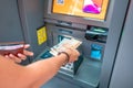 Woman withdraws Armenian drams cash from an ATM. The concept of the exchange rate of currencies and