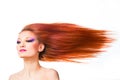 Woman withlong red hair fluttering on wind