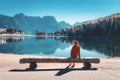 Woman on the wooden bench on the coast of the lake Royalty Free Stock Photo