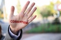 Woman with word CORRUPTION written on her palm outdoors