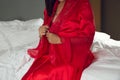 Women in satin nightgown wearing red robes