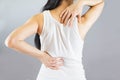 Woman wore white undershirt,hands holding her back in pain and waist .Health-care Concept.Selective focus Royalty Free Stock Photo