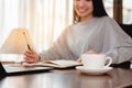 Woman work from home have a coffee cup beside wait epidemic situation to improve soon at home.