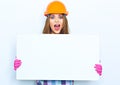 Woman worker builder with open mouth hold big white banner agai Royalty Free Stock Photo