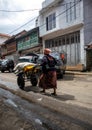 a woman worker carrying goods on a trolley carrying goods at a traditional market