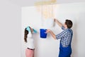 Woman With Worker Collecting Water From Ceiling In Bucket Royalty Free Stock Photo