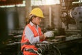 woman worker hard work focus working in heavy metal machine lathe milling factory industry Royalty Free Stock Photo