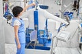 Woman worker Laundry ironed clothes on the automatic steam machine Royalty Free Stock Photo