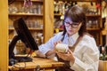 Woman worker manager of restaurant holding wireless banuov payment terminal