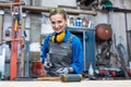 Woman worker marking workpiece in her workshop Royalty Free Stock Photo