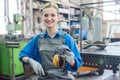 Woman worker in metal factory showing protective workwear