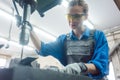 Woman worker in metal workshop using pedestal drill Royalty Free Stock Photo