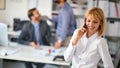 Woman worker at office.business woman enjoying  at workand talking on a mobile phone Royalty Free Stock Photo