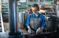 Woman worker operating a machine tool in metal workshop or factory Royalty Free Stock Photo
