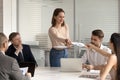 Woman worker share handout materials at briefing in office Royalty Free Stock Photo