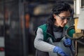 Woman worker wearing safety goggles control lathe machine to drill components. Metal lathe industrial manufacturing Royalty Free Stock Photo