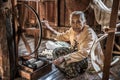 Woman worker weaves fabric in a weaving factory