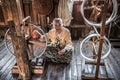 Woman worker weaves fabric in a weaving factory