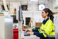 woman worker work control operate CNC wood milling machine in wood furniture workshop. technician staff women working with modern Royalty Free Stock Photo