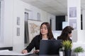 Woman working with blueprints in coworking space Royalty Free Stock Photo