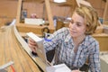 Woman working in boat workshop Royalty Free Stock Photo