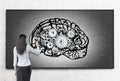 Woman working at brain sketch on blackboard Royalty Free Stock Photo