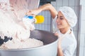 Woman working in butchery making minced meat