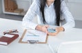 Woman working on celphone, sitting at the desk Royalty Free Stock Photo