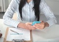 Woman working on celphone, sitting at the desk Royalty Free Stock Photo