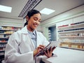 Cheerful woman working in chemist using touchscreen digital tablet Royalty Free Stock Photo
