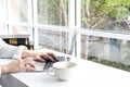 A woman working in a coffee shop. Young female at cafe using laptop. Asian young woman sitting in a restaurant busy working on her Royalty Free Stock Photo