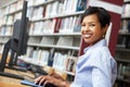 Woman working on computer in library Royalty Free Stock Photo