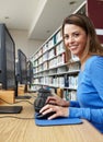 Woman working on computer in library Royalty Free Stock Photo