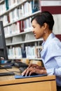 Woman working on computer in library Royalty Free Stock Photo