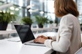 Woman working on computer in modern office, close up. Woman hands typing on keyboard of laptop, online shopping detail Royalty Free Stock Photo