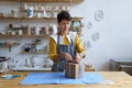 Woman work in craft ceramics store or studio packing pottery in gift box for delivery to consumer