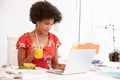 Woman Working In Design Studio Having Lunch At Desk Royalty Free Stock Photo